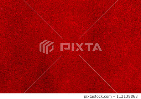 The background is red velvet. Macro photo of natural red suede. Texture of suede leather. 112139868