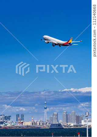 Scenery of Haneda Airport, plane taking off and Tokyo Skytree, Ota Ward, Tokyo 112140668