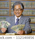 An elderly Japanese man is happily counting money. 112140856