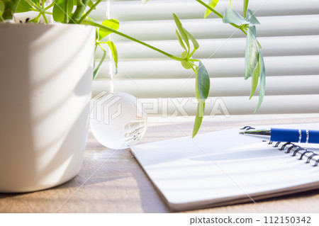 Notepad and blue pen on the windowsill 112150342