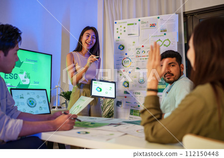 diversity team brainstorming focused on ESG (environment,social,governance) and renewable energy to reduce pollutions in a sustainable green office at night diversity team brainstorming focused on ESG (environment,social,governance) and renewable energy to reduce pollutions in a sustainable green office at night 112150448