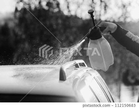 Cleaning car using high pressure water. 112150683