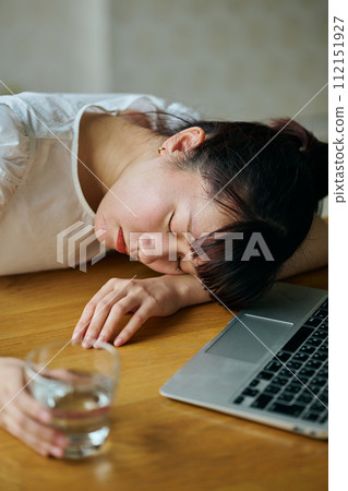 Young woman sitting at her desk Young woman sitting at her desk 112151927