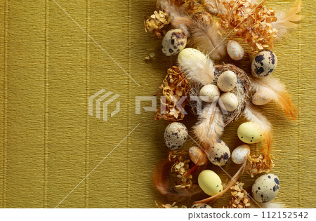 Easter composition with quail eggs, feathers, and dried flowers. Easter composition with quail eggs, feathers, and dried flowers. 112152542