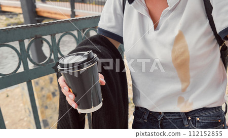 Coffee spilled on white shirt 112152855