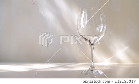 the dynamic elegance of a wine glass, capturing the interplay of light and liquid 112153017