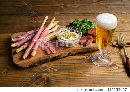 Snacks such as raw ham, grissini, and dips 112153437