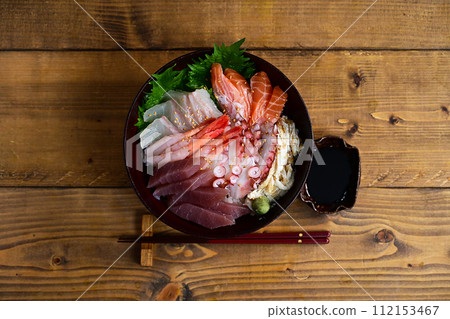 Bowl of rice topped with sashimi Bowl of rice topped with sashimi 112153467