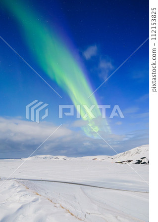 Aurora Borealis in Iceland. Northern Lights over snow field. 112153825
