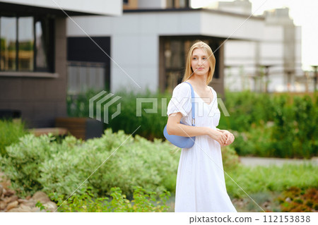 Blonde woman waiting for taxi in townhouse 112153838