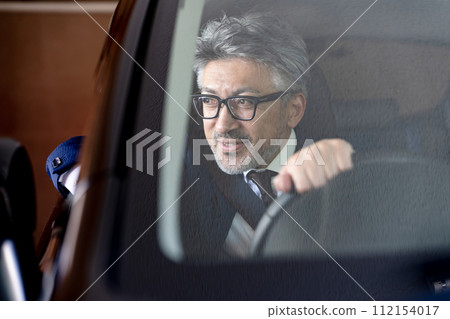 Senior male business driving Senior male business driving 112154017