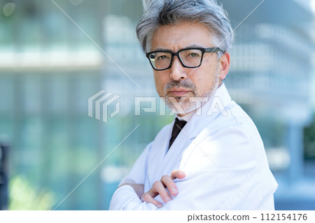 Senior male, white coat, arms folded Senior male, white coat, arms folded 112154176