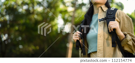Cropped shot female tourist with backpack hiking at springtime. Travel and active life concept 112154774
