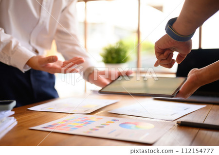 Two young creative designer working on mobile application software design project in office Two young creative designer working on mobile application software design project in office 112154777