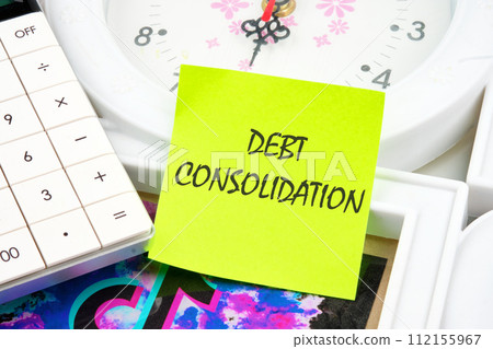 Debt consolidation. This is the process of obtaining a new loan to repay a number of existing debts. The text is written on a yellow sticker near the calculator and the clock Debt consolidation. This is the process of obtaining a new loan to repay a number of existing debts. The text is written on a yellow sticker near the calculator and the clock 112155967