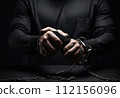 criminal's hands are shackled. bandit in handcuffs. the topic of crime and punishment. 112156096