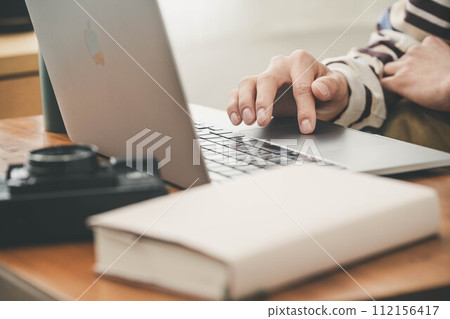 Hands of a man playing with a laptop Hands of a man playing with a laptop 112156417