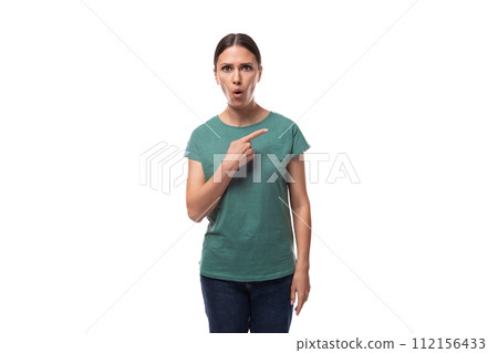 attractive young caucasian woman with black hair in a t-shirt points her hand to the side in attractive young caucasian woman with black hair in a t-shirt points her hand to the side in 112156433
