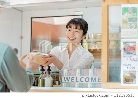 Kitchen car: Woman passing lunch box 112156535