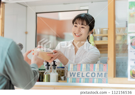 Kitchen car: Woman passing lunch box Kitchen car: Woman passing lunch box 112156536