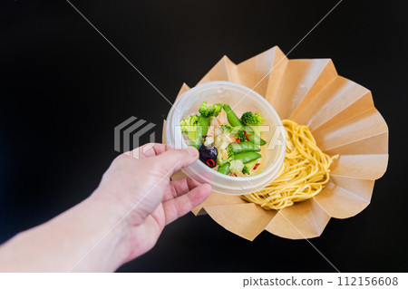 Cup-style bellows container with pasta at the bottom and ingredients separated at the top Cup-style bellows container with pasta at the bottom and ingredients separated at the top 112156608