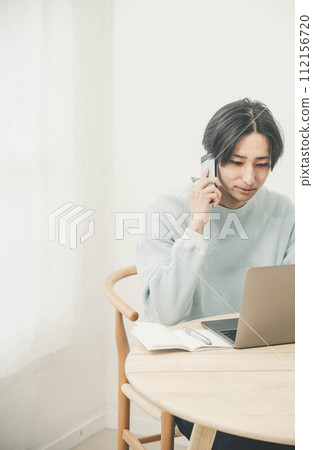 A young man calling by telework A young man calling by telework 112156720