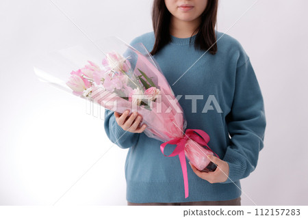 Teenage woman with a bouquet of flowers Teenage woman with a bouquet of flowers 112157283