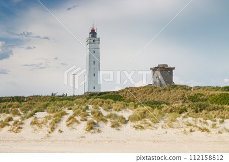 Lighthouse and bunker in the sand dunes on the beach of Blavand, Jutland Denmark Europe 112158812