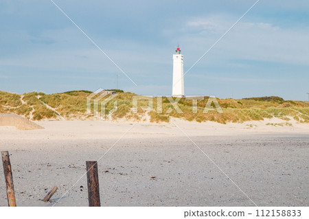 Lighthouse and bunker in the sand dunes on the beach of Blavand, Jutland Denmark Europe 112158833