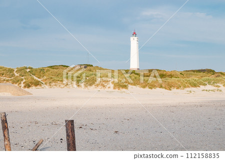 Lighthouse and bunker in the sand dunes on the beach of Blavand, Jutland Denmark Europe 112158835
