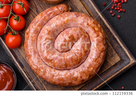 Delicious grilled sausage in the form of a ring with salt, spices and herbs 112159336