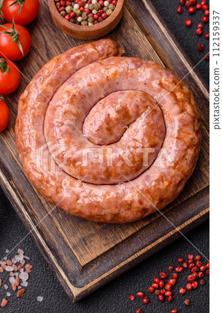 Delicious grilled sausage in the form of a ring with salt, spices and herbs 112159337