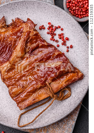 Delicious smoked or grilled ribs with olives, spices and herbs Delicious smoked or grilled ribs with olives, spices and herbs 112159385