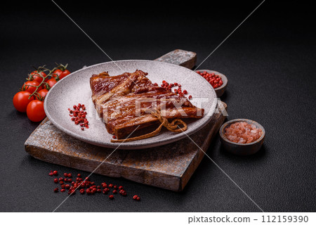 Delicious smoked or grilled ribs with olives, spices and herbs Delicious smoked or grilled ribs with olives, spices and herbs 112159390