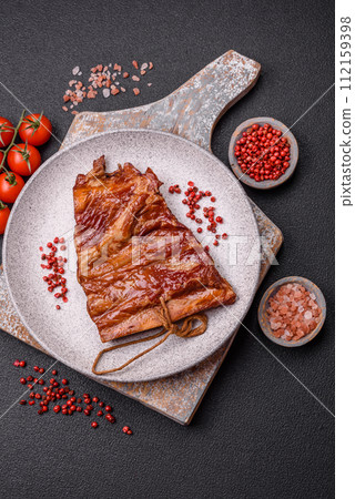 Delicious smoked or grilled ribs with olives, spices and herbs 112159398