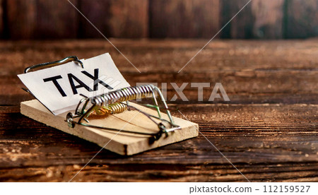 Piece of Paper with TAX Text on a Mouse Trap - Generative Ai 112159527