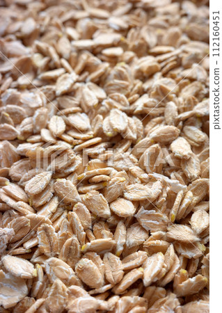 Close up photo of spelt flakes, selective focus, food background. 112160451
