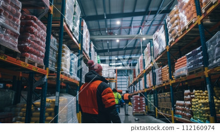 AI-generated content. Warehouse worker checking inventory in a large cold store 112160974