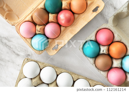 Multi-colored Easter chicken eggs lie on table. close-up, flat lay. top view Multi-colored Easter chicken eggs lie on table. close-up, flat lay. top view 112161214
