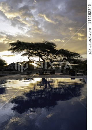 Tanzania, Serengeti, sunset over the swimming pool of the Masek tent camp 112162246