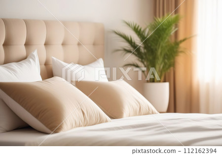 Clean bed. Light bedroom. Modern apartment interior. White sheet, soft pillow, blanket and bedside table. Home, hotel stylish design. Comfortable grey bedding set closeup. Spa resort ad. Rent business 112162394