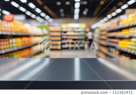 Empty table top with supermarket blurred defocused panorama, bokeh light. Backdrop for display or montage products. Blank gray steel counter with blur grocery, market store background. Front view 112162431