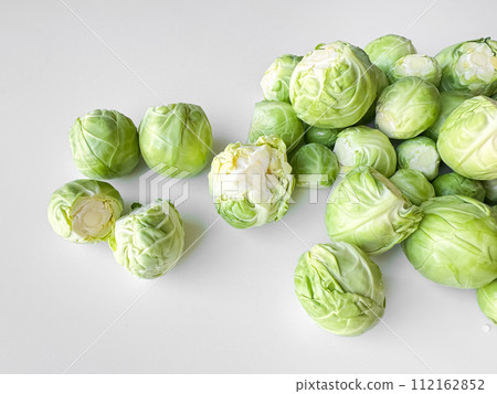 Fresh Brussels sprouts on white background, healthy green vegetable concept with copy space. Fresh Brussels sprouts on white background, healthy green vegetable concept with copy space. 112162852