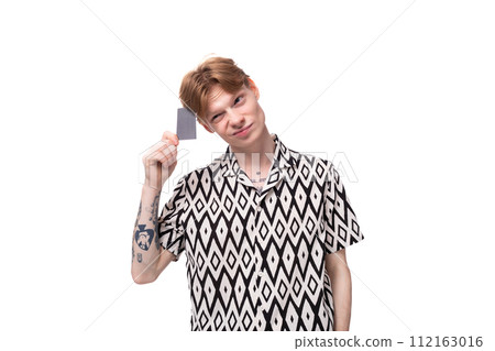 young caucasian man with reddish golden hair holding a credit card with mockup young caucasian man with reddish golden hair holding a credit card with mockup 112163016