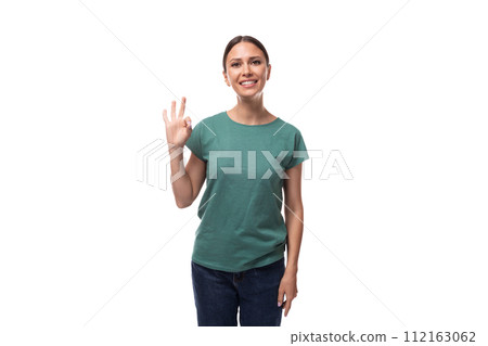 young woman in t-shirt and jeans showing ok and approval gesture 112163062