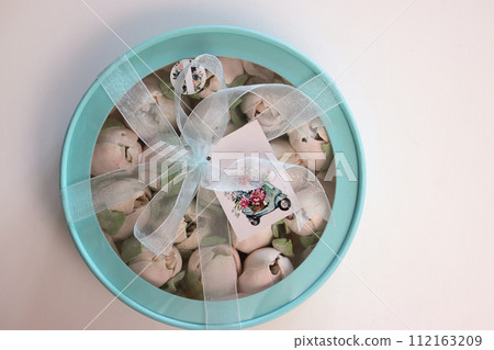 Zephyr in a box. The box is tied with a ribbon. View from above. 112163209