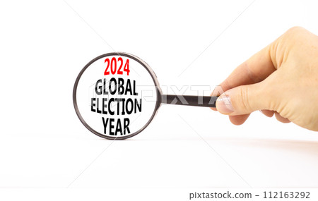 2024 global election year symbol. Concept words 2024 global election year on beautiful magnifying glass. Beautiful white background. Voter hand. Business 2024 global election year concept. Copy space 112163292