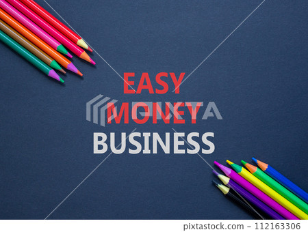 Easy money business symbol. Concept words Easy money business on beautiful black paper. Beautiful black table black background. Colored pencils. Easy money business concept. Copy space. Easy money business symbol. Concept words Easy money business on beautiful black paper. Beautiful black table black background. Colored pencils. Easy money business concept. Copy space. 112163306