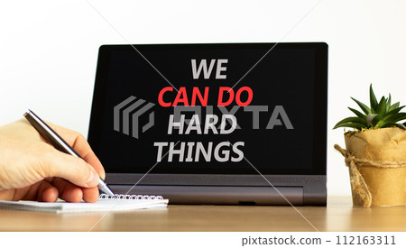 We can do hard things symbol. Concept words We can do hard things on beautiful black tablet. Beautiful white background. Businessman hand. Business, we can do hard things concept. Copy space. 112163311
