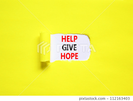 Help give hope symbol. Concept word Help give hope on beautiful white paper. Beautiful yellow table yellow background. Business motivational help give hope concept. Copy space. 112163403